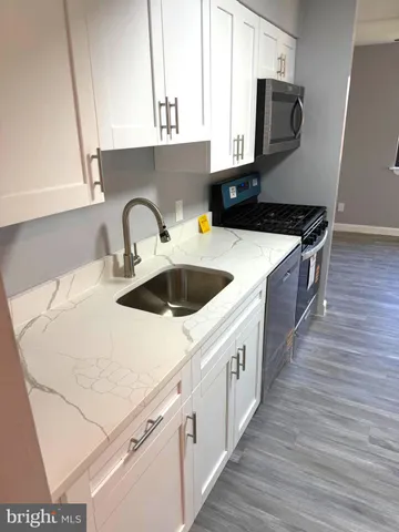 a kitchen with stainless steel appliances a sink and a microwave