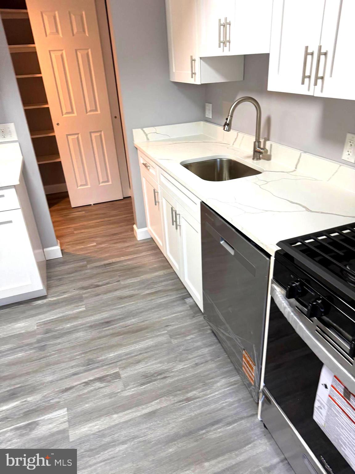 6029 Majors Lane, Unit 4 C16 Columbia, MD 21045 - Photo 36 of 51 a kitchen with a sink and a stove top oven