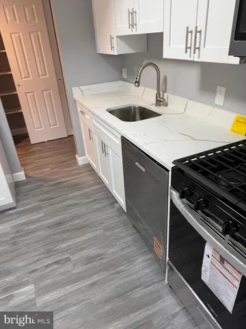 a kitchen with a sink stove and cabinets