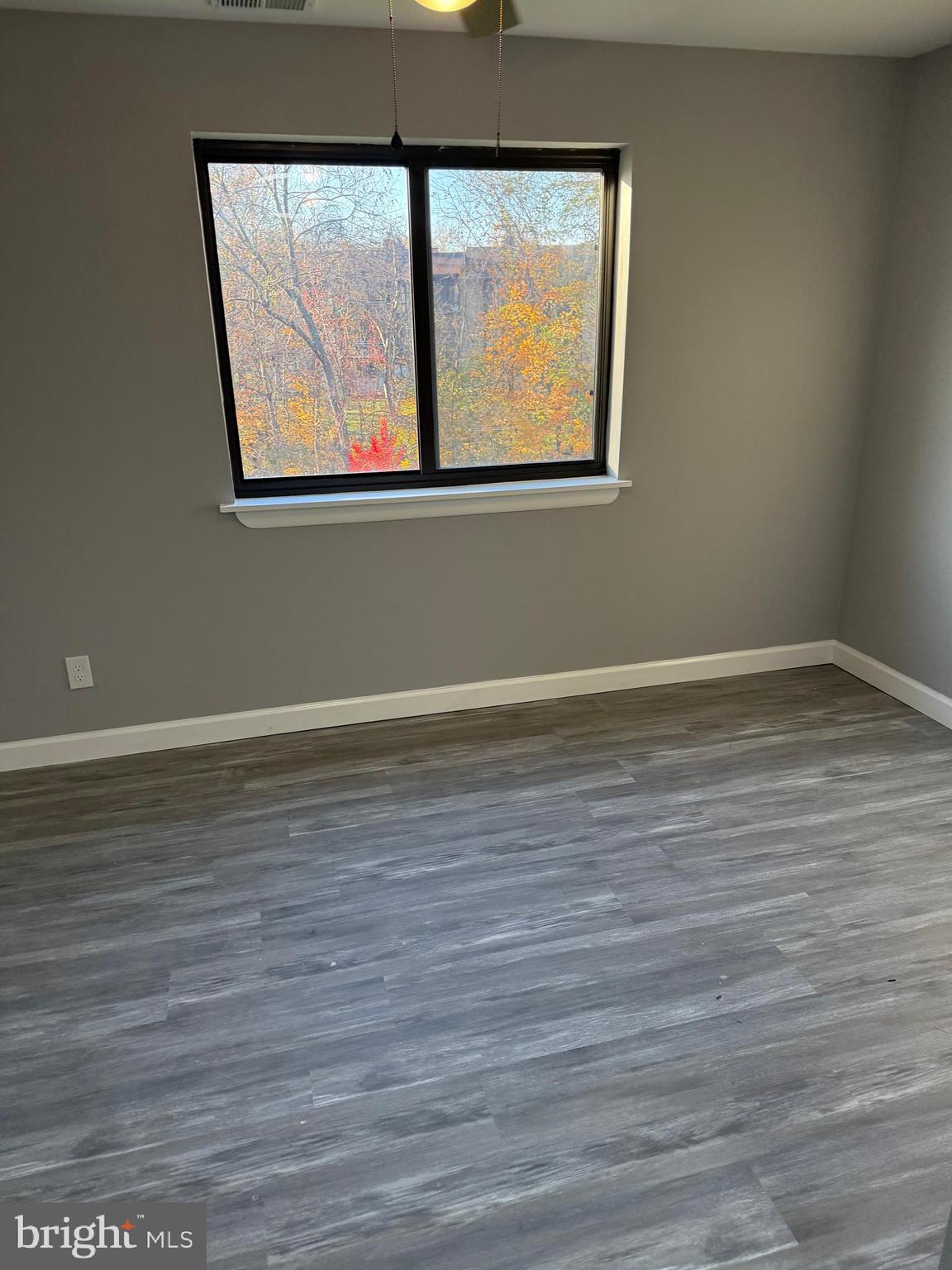 6029 Majors Lane, Unit 4 C16 Columbia, MD 21045 - Photo 40 of 51 a view of a room has wooden floor and a window