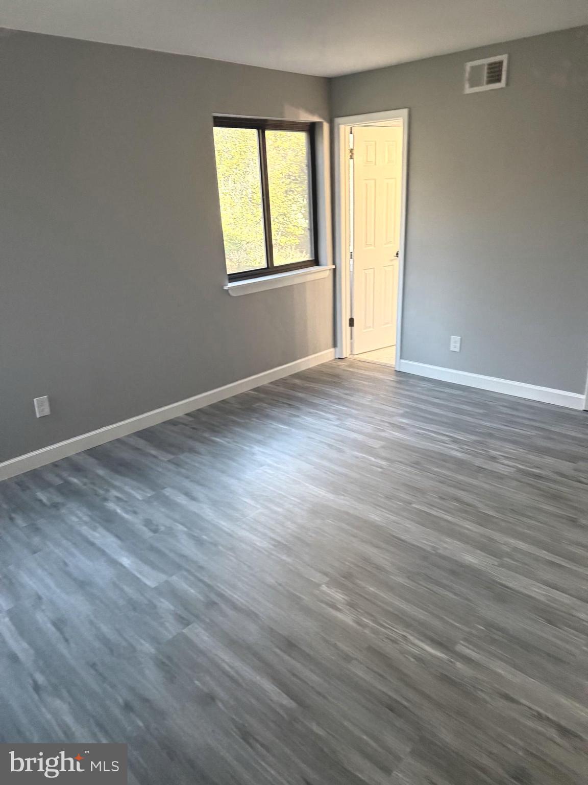 6029 Majors Lane, Unit 4 C16 Columbia, MD 21045 - Photo 4 of 51 an empty room with wooden floor and windows