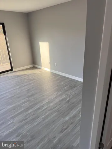 a view of an empty room and wooden floor