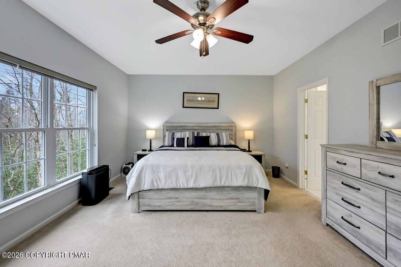 134 Skytop Road Long Pond, PA 18334 - Photo 14 of 48 a spacious bedroom with a bed and a window