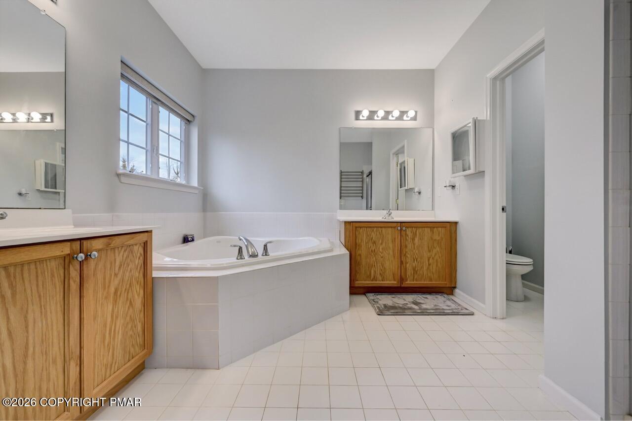 134 Skytop Road Long Pond, PA 18334 - Photo 15 of 48 a spacious bathroom with a tub sink shower and mirror