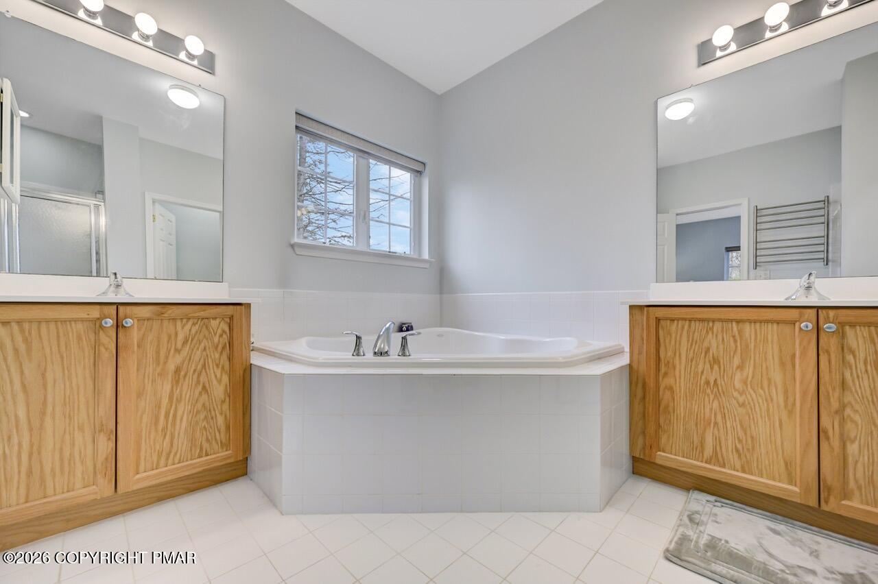 134 Skytop Road Long Pond, PA 18334 - Photo 16 of 48 a bathroom with a sink a mirror and a shower