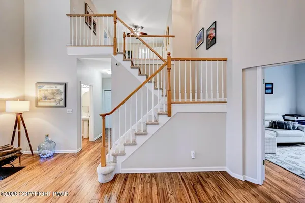 a living room with dining room and wooden floor
