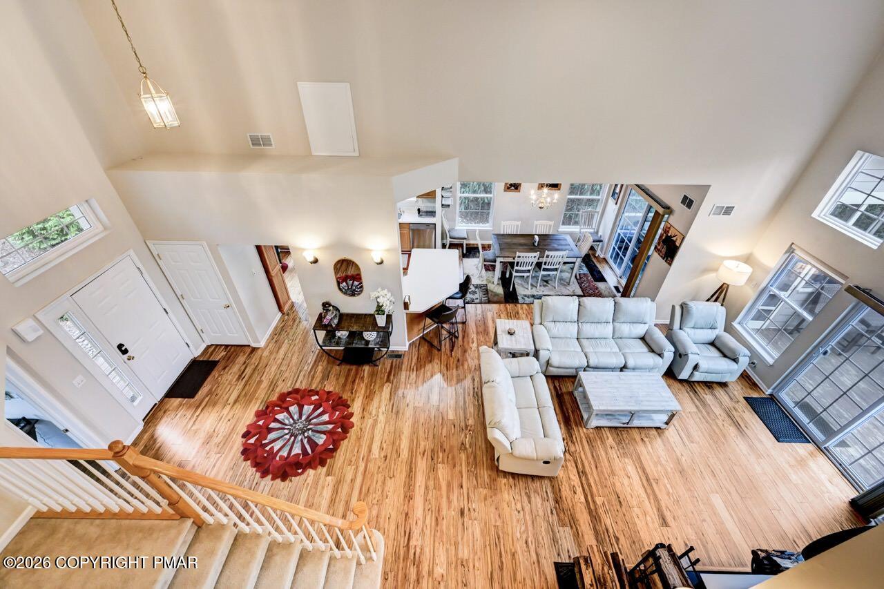 134 Skytop Road Long Pond, PA 18334 - Photo 20 of 48 a living room with dining room and wooden floor