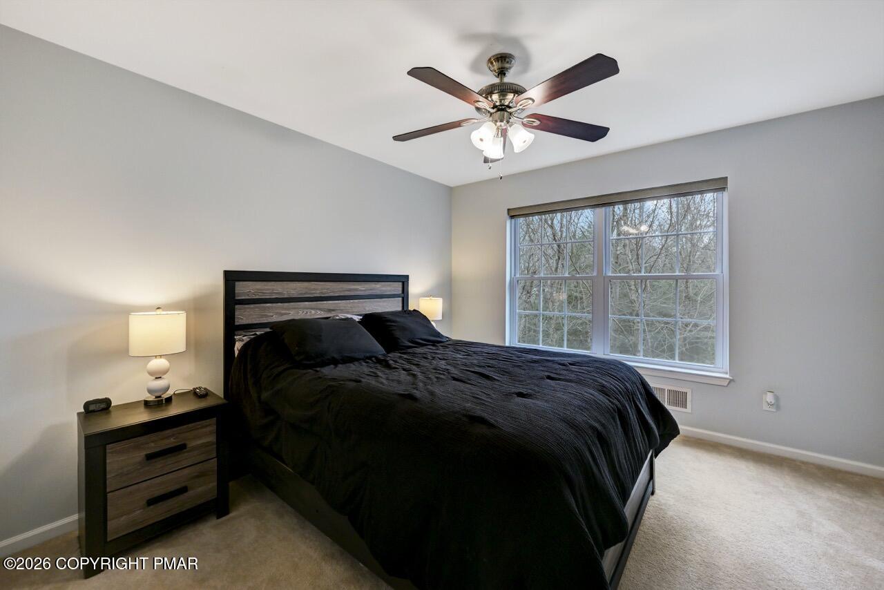 134 Skytop Road Long Pond, PA 18334 - Photo 21 of 48 a bed sitting in a bedroom next to a window