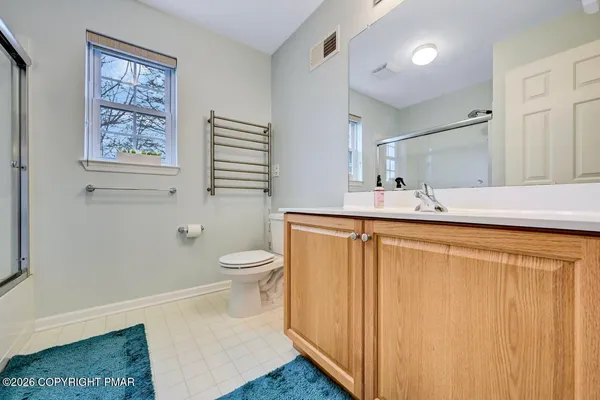 a bathroom with a glass shower door