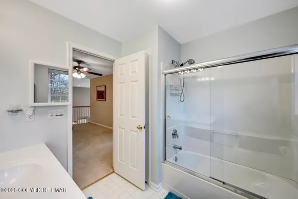 a bathroom with double vanity and a mirror