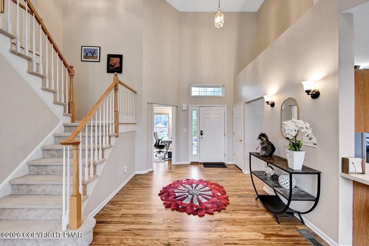 134 Skytop Road Long Pond, PA 18334 - Photo 3 of 48 a living room with wooden floor and white walls