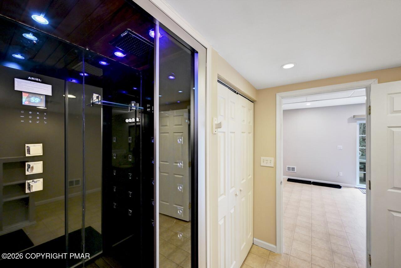 134 Skytop Road Long Pond, PA 18334 - Photo 37 of 48 a bathroom with a glass shower door