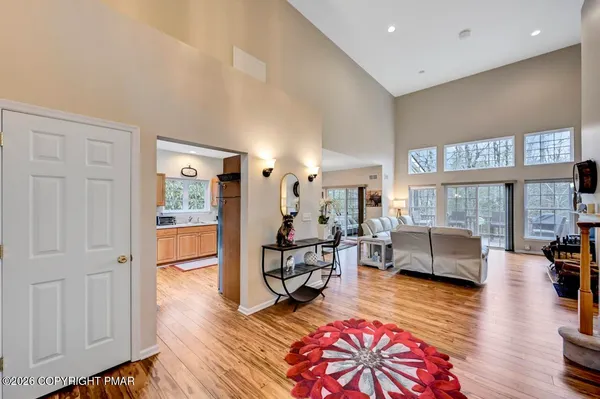 a living room with furniture a fireplace and a floor to ceiling window