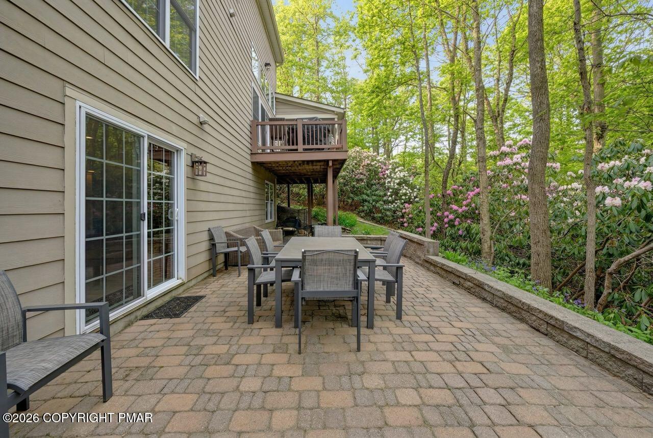 134 Skytop Road Long Pond, PA 18334 - Photo 40 of 48 a view of a patio with table and chairs with wooden floor and fence