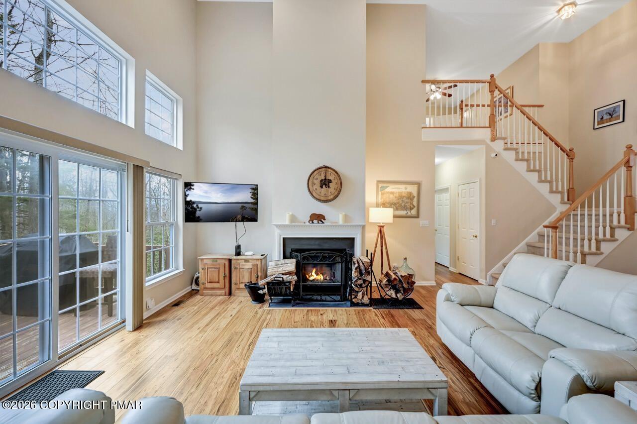 134 Skytop Road Long Pond, PA 18334 - Photo 6 of 48 a living room with furniture a fireplace and a floor to ceiling window
