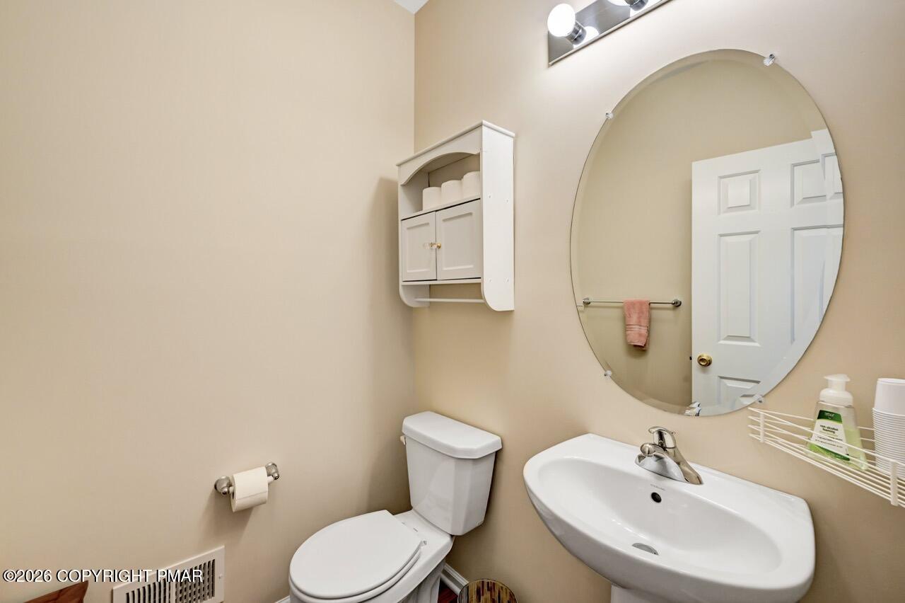 134 Skytop Road Long Pond, PA 18334 - Photo 7 of 48 a bathroom with a toilet a sink and mirror