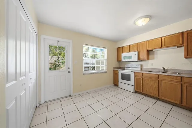a kitchen with a sink cabinets and window
