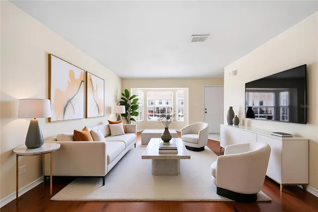 a living room with furniture wooden floor and a large window