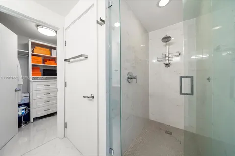 a bathroom with a shower and a sink