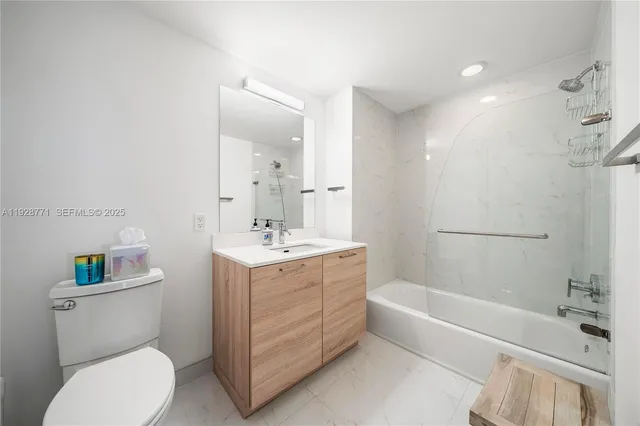 a bathroom with a sink toilet vanity and bathtub