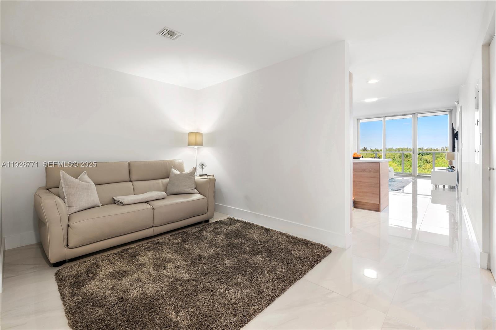 16385 Biscayne Boulevard, Unit 503 North Miami Beach, FL 33160 - Photo 17 of 50 a living room with furniture and a rug