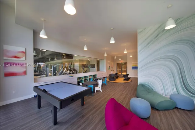 a living room with furniture kitchen view and a large window