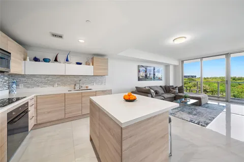 a view of kitchen with wooden floor sink stove and refrigerator