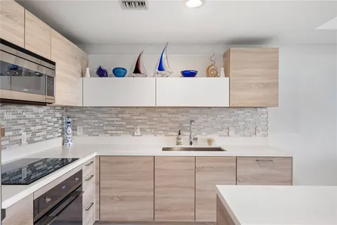 a kitchen with sink cabinets and stove