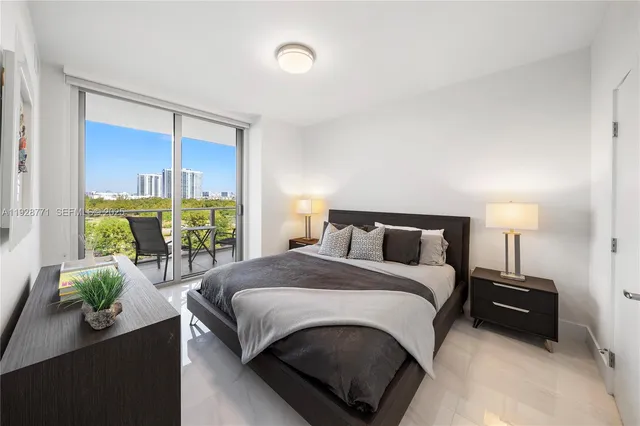a bedroom with a bed lamp and a potted plant