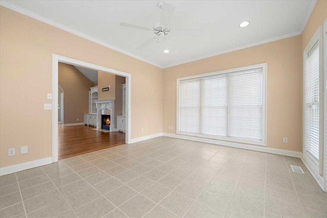128 Cayman Way Anderson, SC 29621 - Photo 8 of 49 This bright space features sleek tile flooring, a refreshing ceiling fan, and ample natural light.
