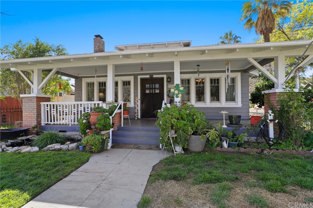 4394 11th Street Riverside, CA 92501 - Photo 1 of 1 a view of a house with brick walls and a yard with plants