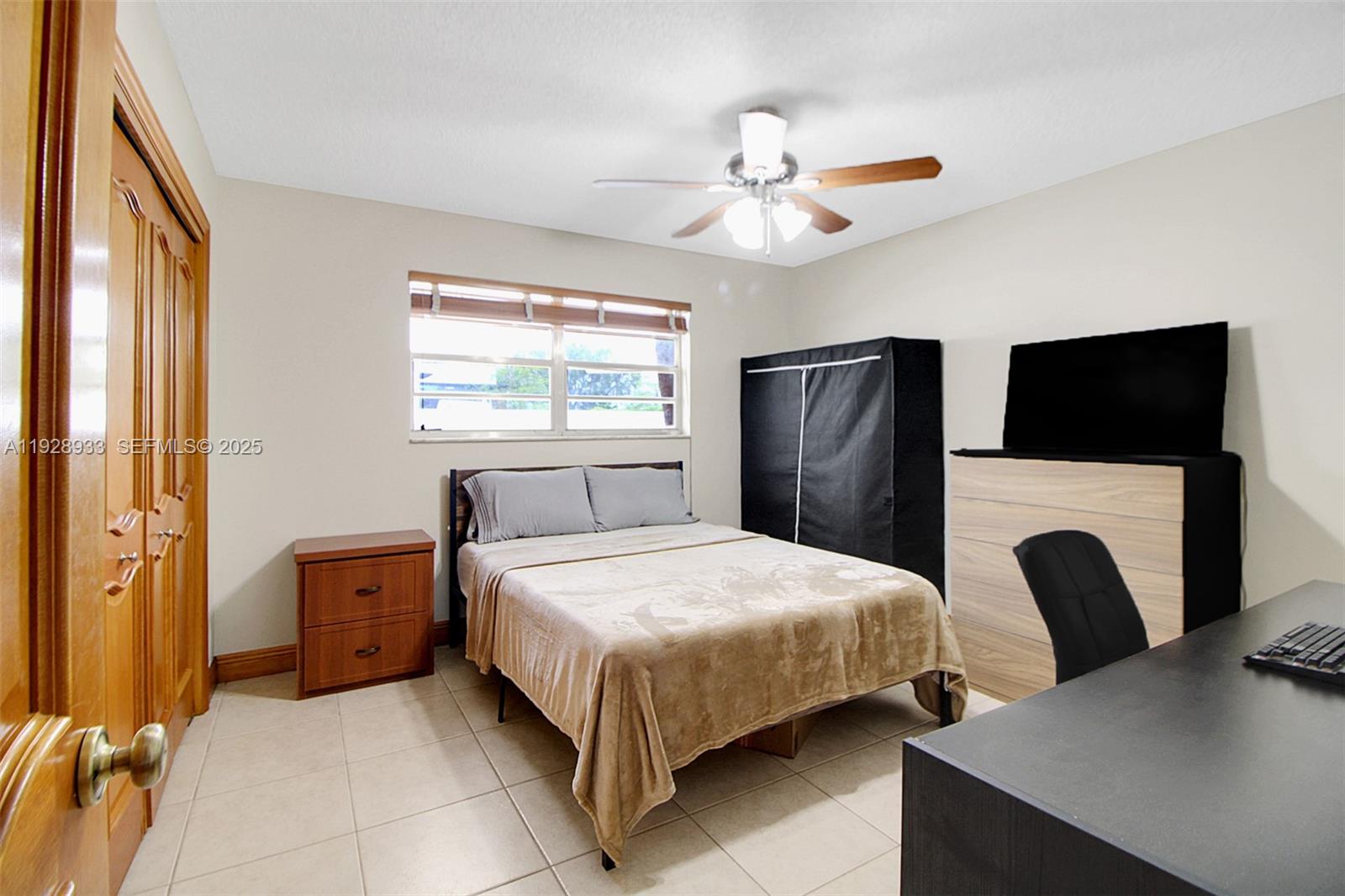 50 Southwest 130th Avenue Miami, FL 33184 - Photo 29 of 70 a bedroom with a bed and a chandelier