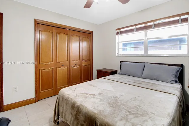 a backyard of a house with plants and wooden fence