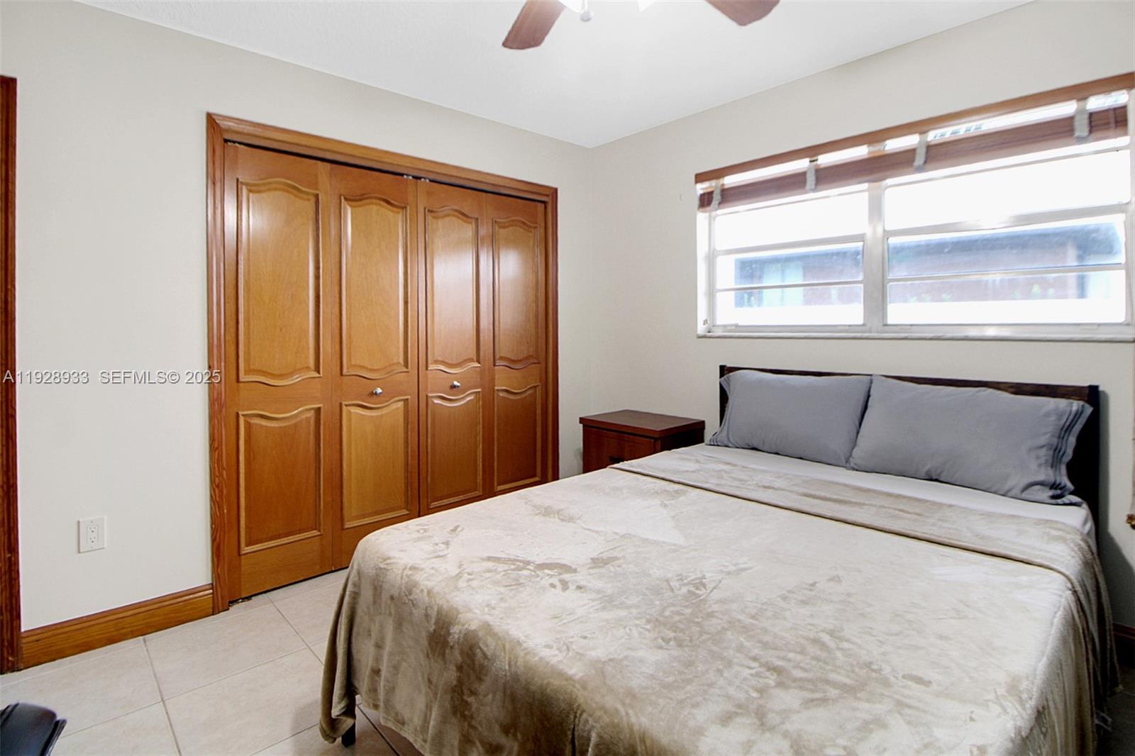 50 Southwest 130th Avenue Miami, FL 33184 - Photo 30 of 70 a bedroom with a bed and a window