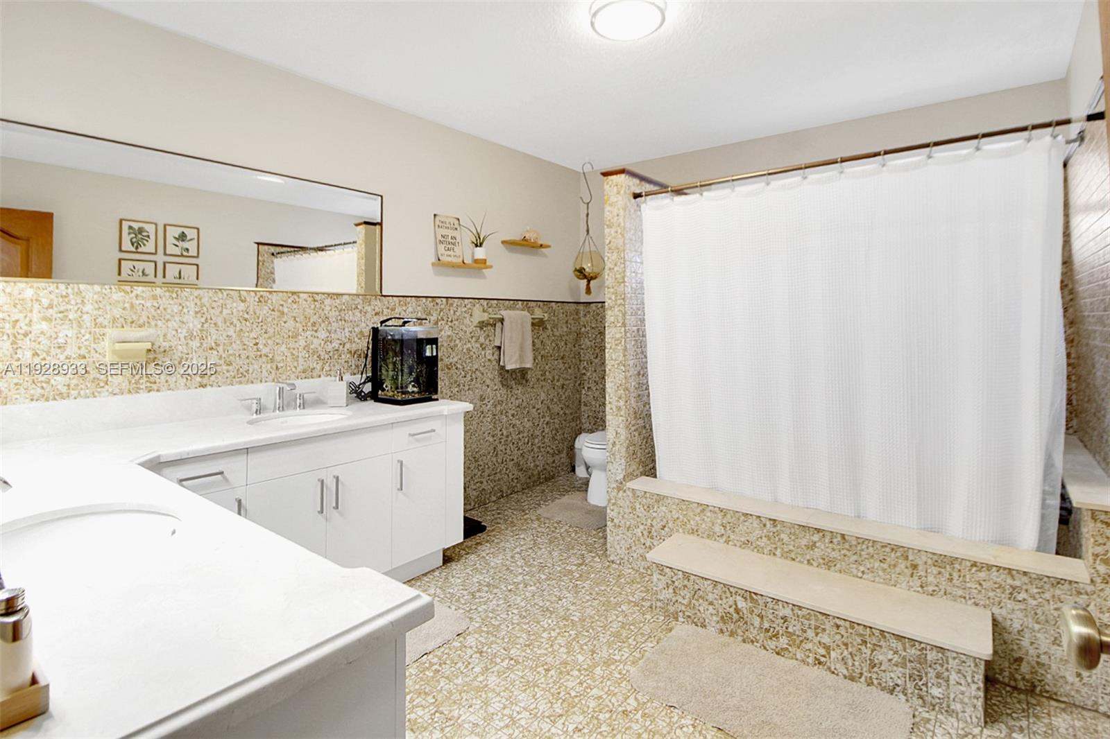 50 Southwest 130th Avenue Miami, FL 33184 - Photo 31 of 70 a bathroom with a granite countertop sink and a bathtub