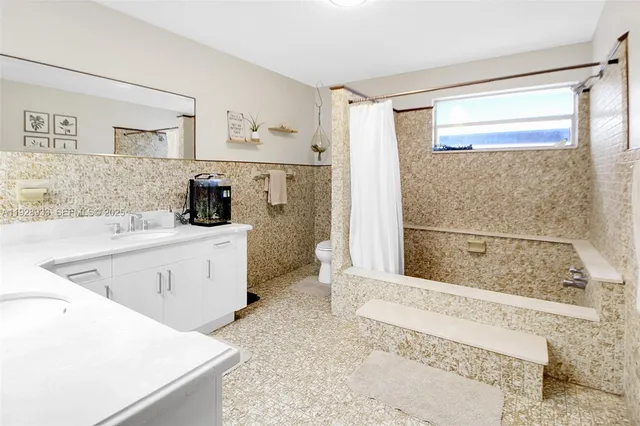 a living room with furniture a window and a flat screen tv