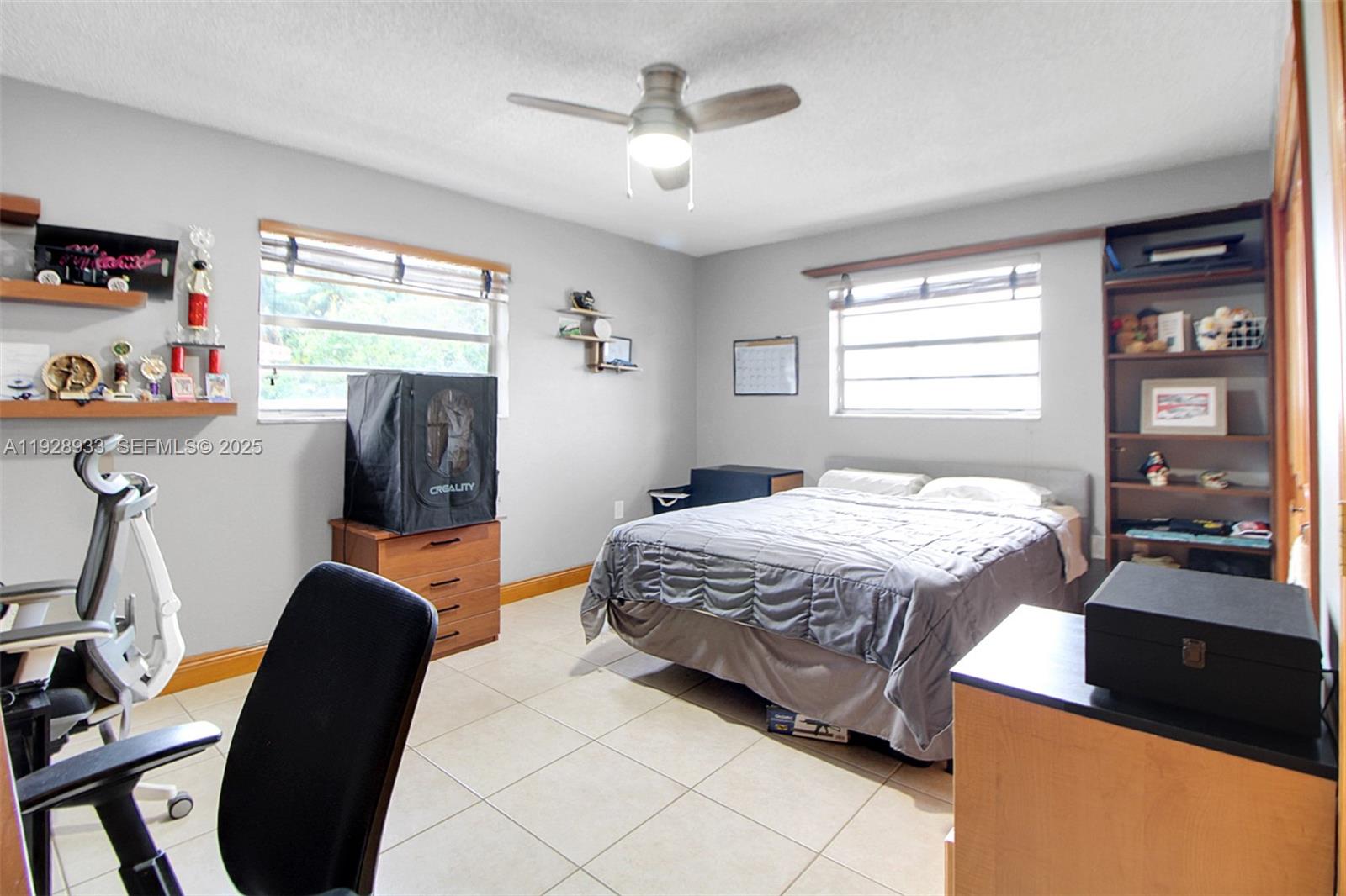 50 Southwest 130th Avenue Miami, FL 33184 - Photo 34 of 70 a bedroom with a bed and a chandelier