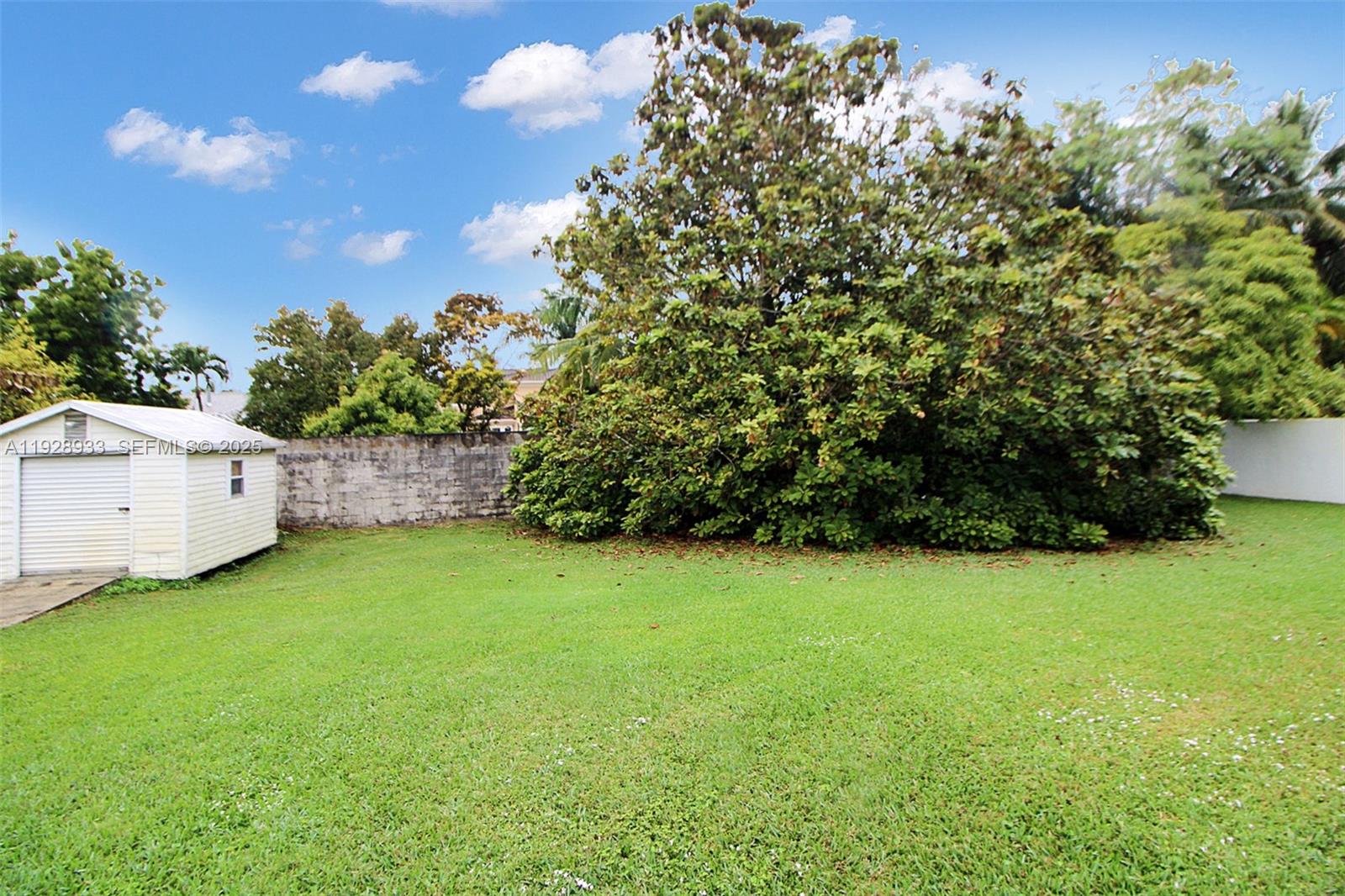 50 Southwest 130th Avenue Miami, FL 33184 - Photo 42 of 70 a backyard of a house with plants and wooden fence