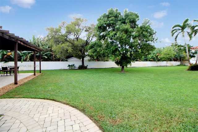 a view of house with yard and entertaining space