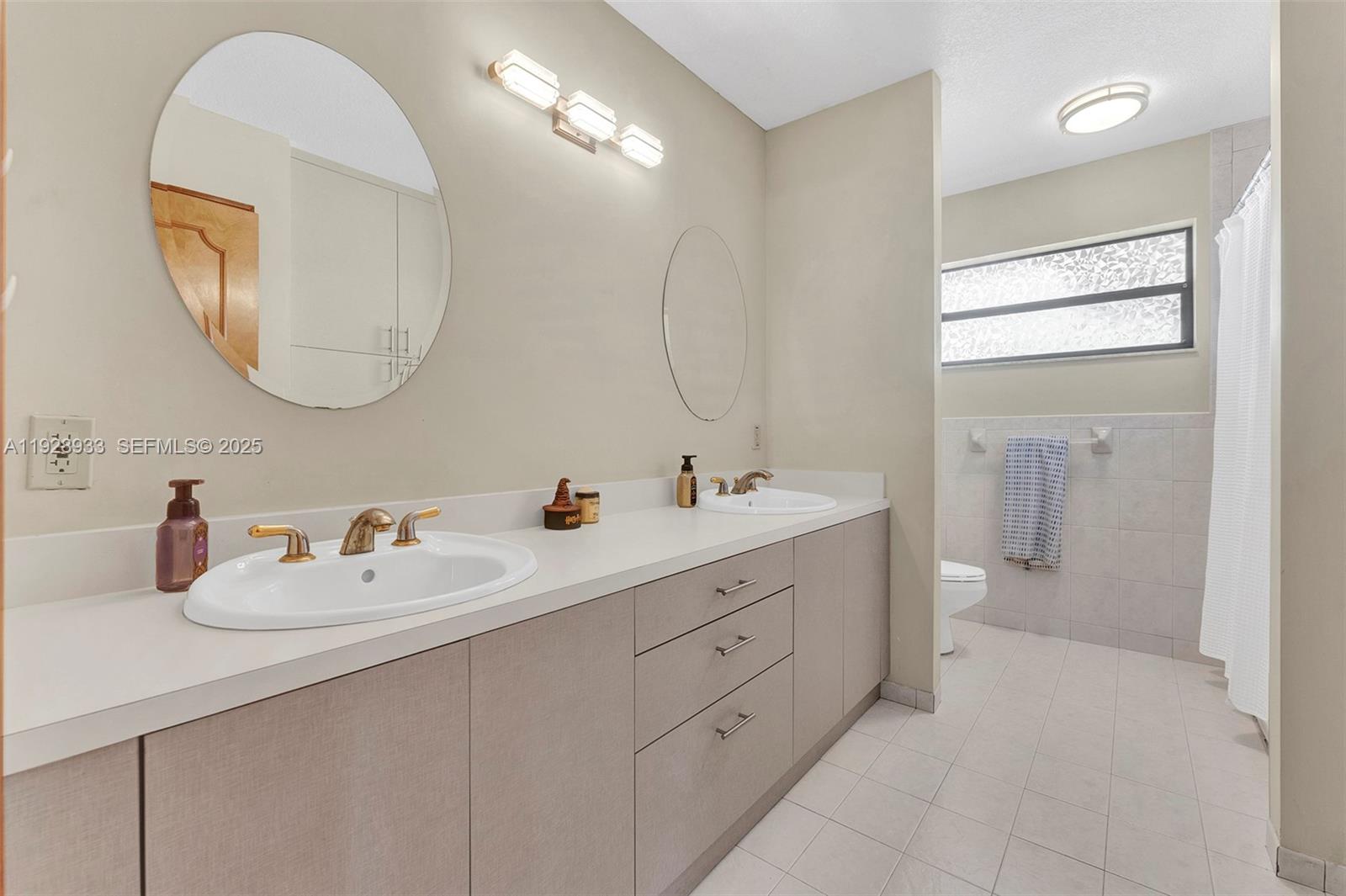 50 Southwest 130th Avenue Miami, FL 33184 - Photo 52 of 70 a bathroom with a double vanity sink and a mirror