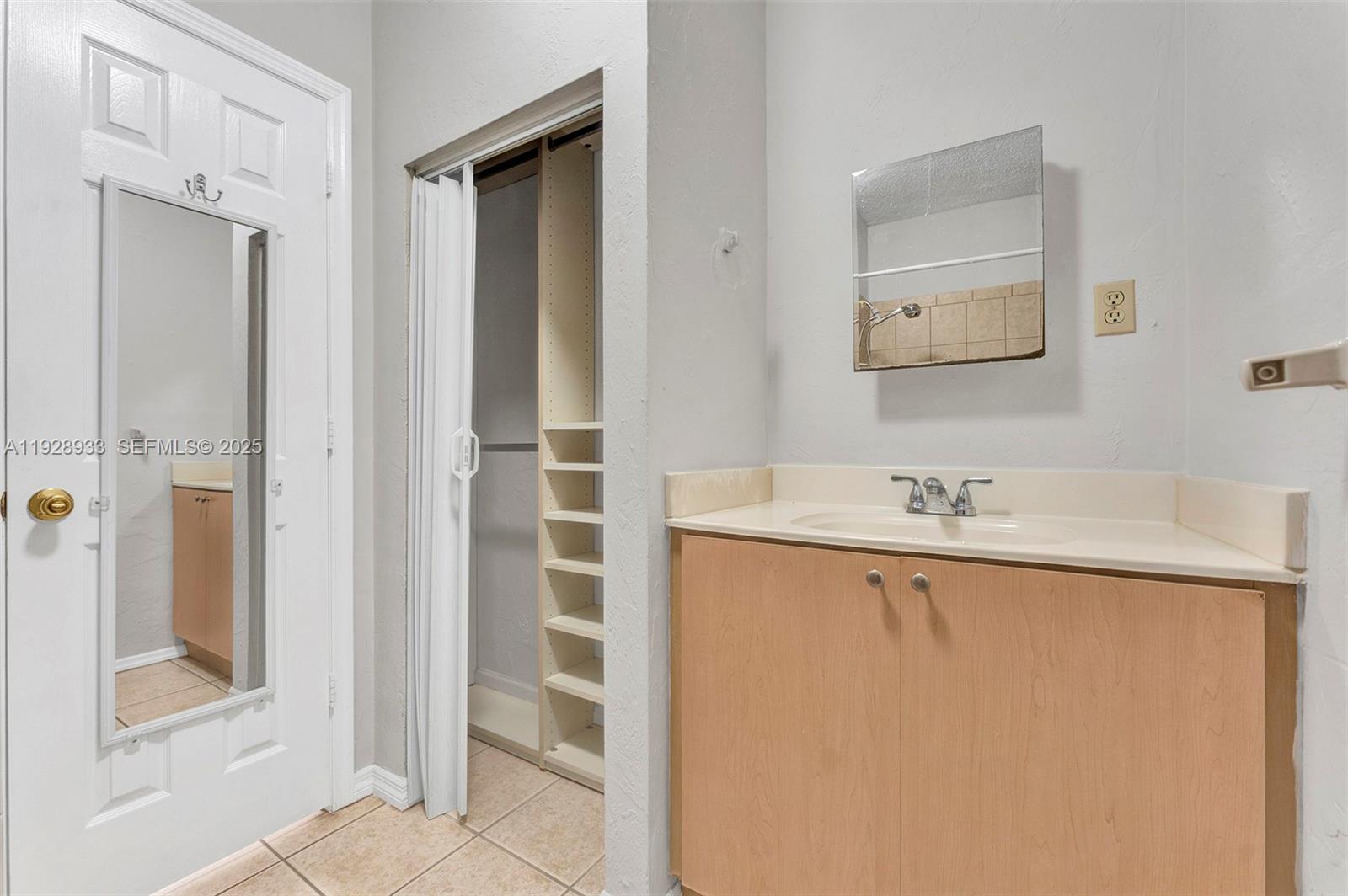 50 Southwest 130th Avenue Miami, FL 33184 - Photo 69 of 70 a bathroom with a sink a mirror and a shower