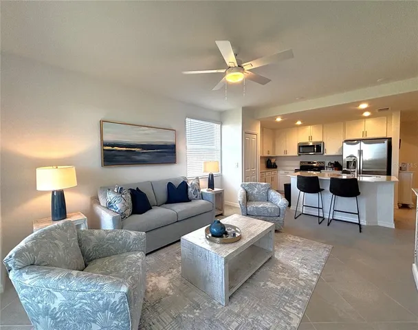 a living room with furniture and kitchen view