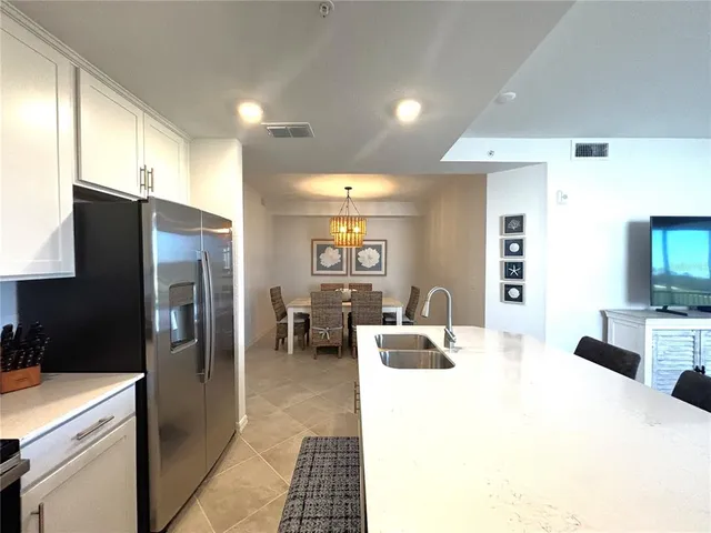 a kitchen with stainless steel appliances a refrigerator and a stove
