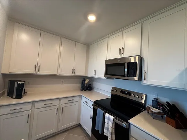 a kitchen with a sink stove and microwave