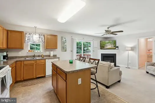 a kitchen with sink refrigerator and window
