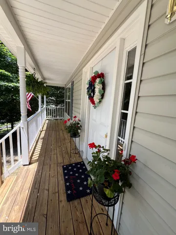 a view of a chairs and table on the balcony
