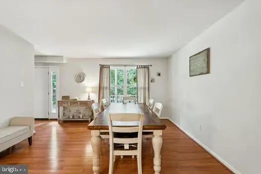 a dining room with furniture and wooden floor