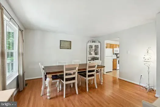 a dining room with furniture and wooden floor