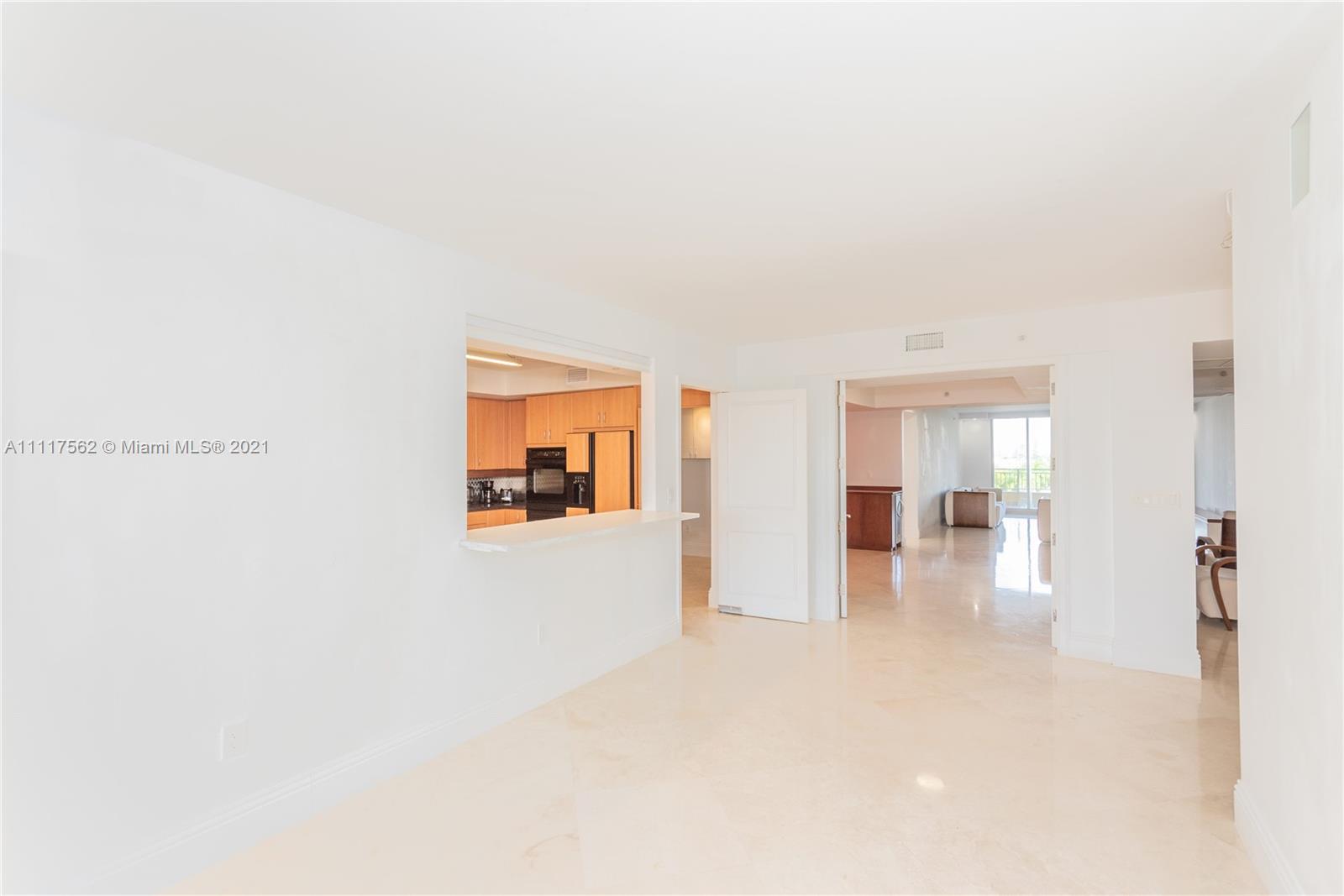 765 Crandon Boulevard, Unit 504 Key Biscayne, FL 33149 - Photo 12 of 46 a view of a hallway with wooden floor and a bathroom