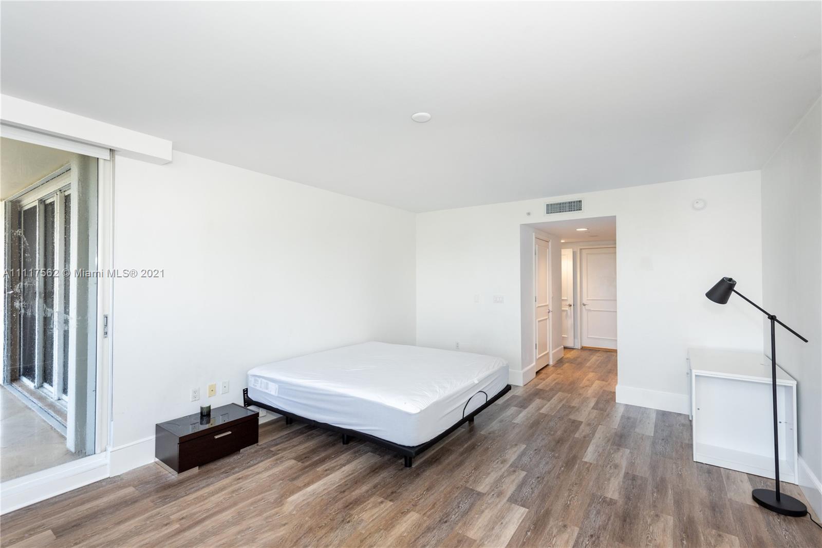 765 Crandon Boulevard, Unit 504 Key Biscayne, FL 33149 - Photo 13 of 46 a bedroom with a bed and wooden floor